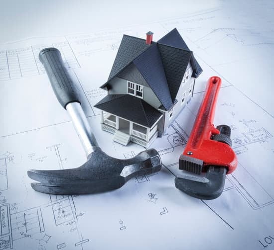 Image: Homeowner reviewing tax documents. Can I Deduct Interest Paid on a Home Improvement Loan?