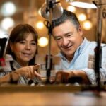 Two people proudly claim home energy improvements, saving money and the environment